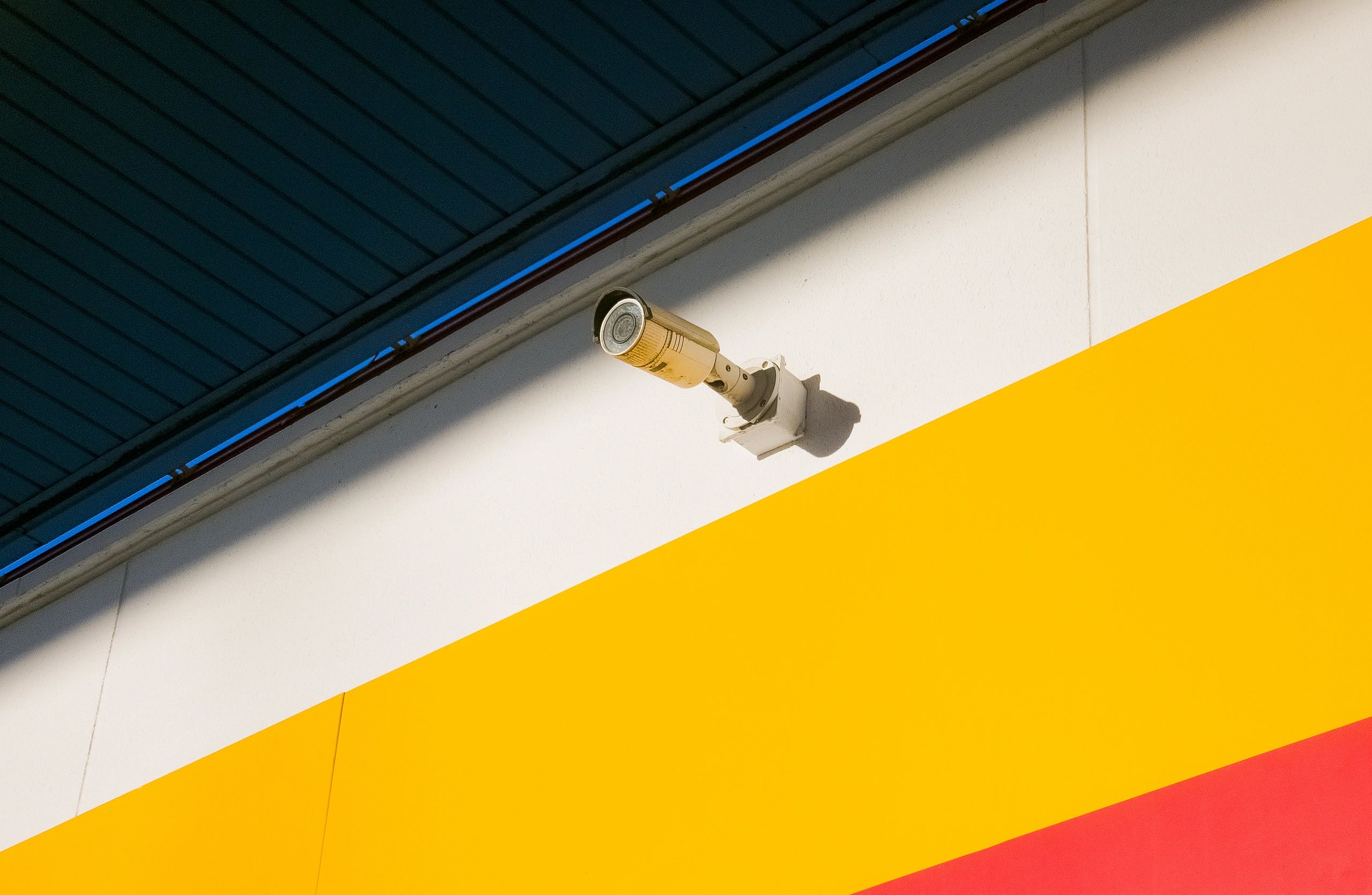 Security camera installed on an exterior wall representing professional technology installation services